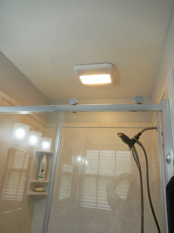Small transitional alcove shower photo with white walls, an integrated sink and a two-piece toilet