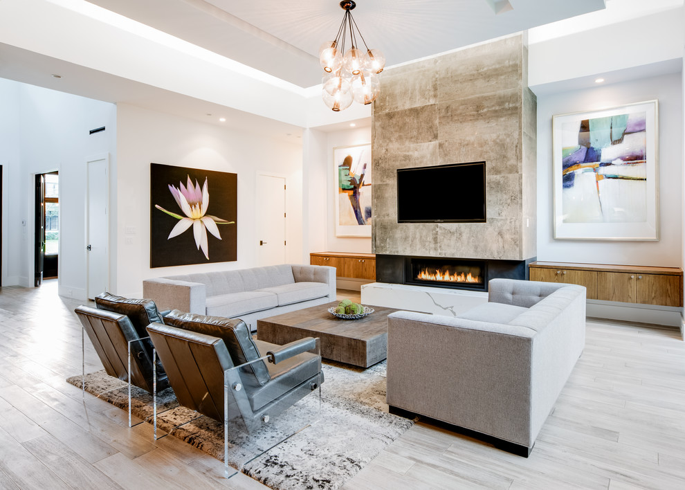 Design ideas for a mid-sized contemporary open concept family room in Dallas with white walls, a ribbon fireplace, a tile fireplace surround, a built-in media wall, grey floor and light hardwood floors.