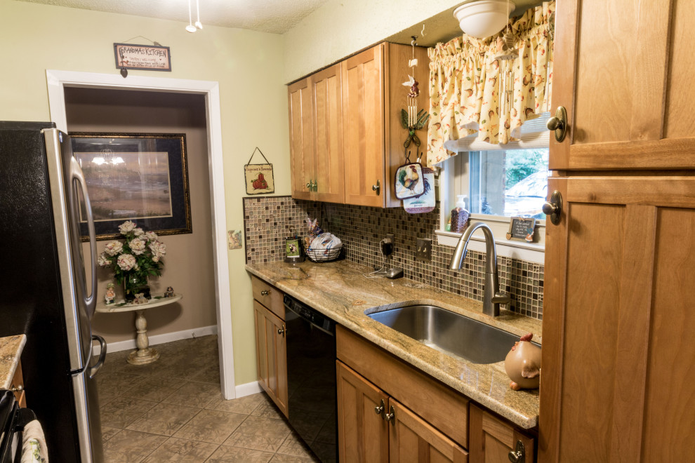 Eat-in kitchen - mid-sized galley cement tile floor and brown floor eat-in kitchen idea with an undermount sink, shaker cabinets, brown cabinets, granite countertops, brown backsplash, glass tile backsplash, stainless steel appliances, no island and brown countertops