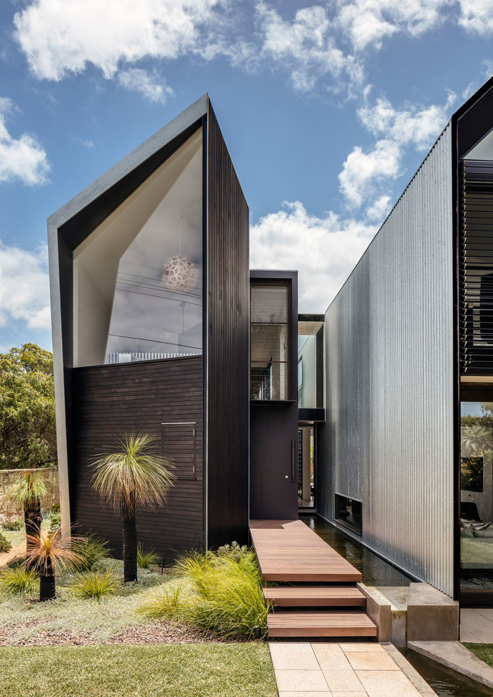 This is an example of a contemporary house exterior in Sydney with metal siding and a metal roof.