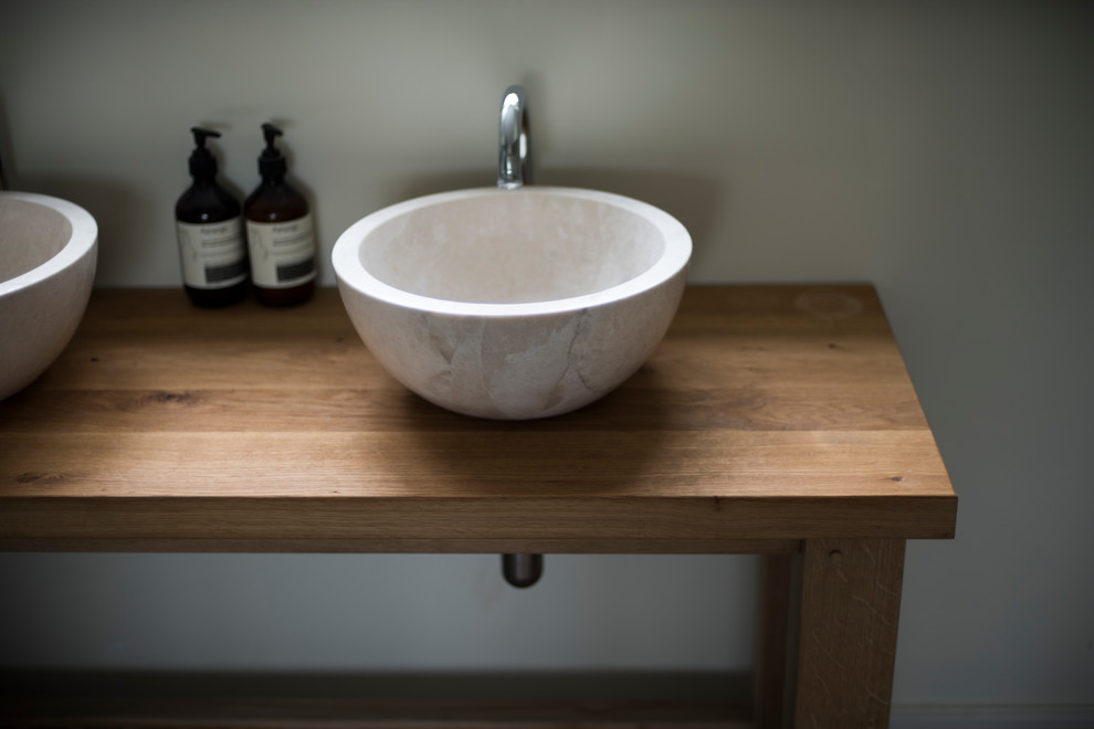 Inspiration for a mid-sized contemporary master bathroom in Wiltshire with medium wood cabinets, a one-piece toilet, white walls, medium hardwood floors, wood benchtops, brown floor and furniture-like cabinets.
