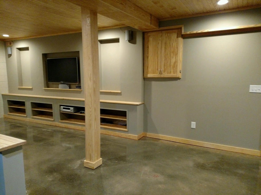 This is an example of a large country walk-out basement in Other with grey walls, concrete floors and no fireplace.