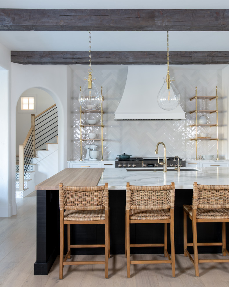 Inspiration for a transitional kitchen remodel in Dallas with marble countertops, white backsplash, an island and white countertops