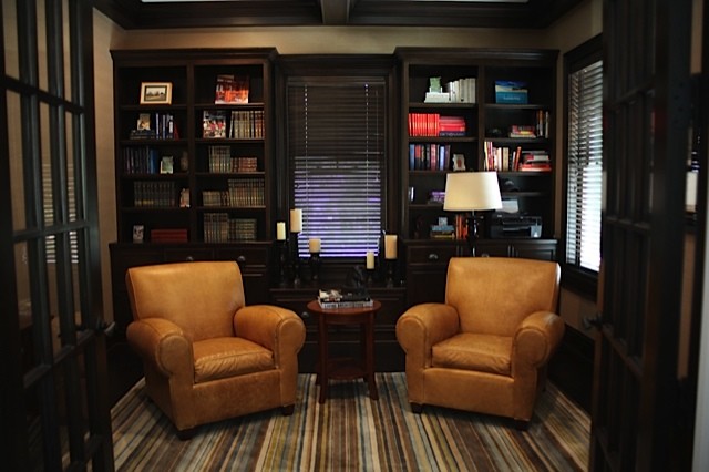 Inspiration for a small contemporary enclosed family room in Chicago with a library, beige walls, dark hardwood floors, no fireplace and no tv.