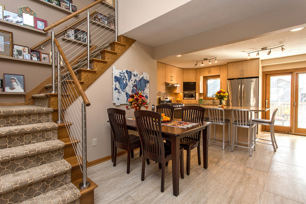 Mid-sized transitional l-shaped open concept kitchen photo with an undermount sink, flat-panel cabinets, light wood cabinets, stainless steel appliances, an island and beige backsplash