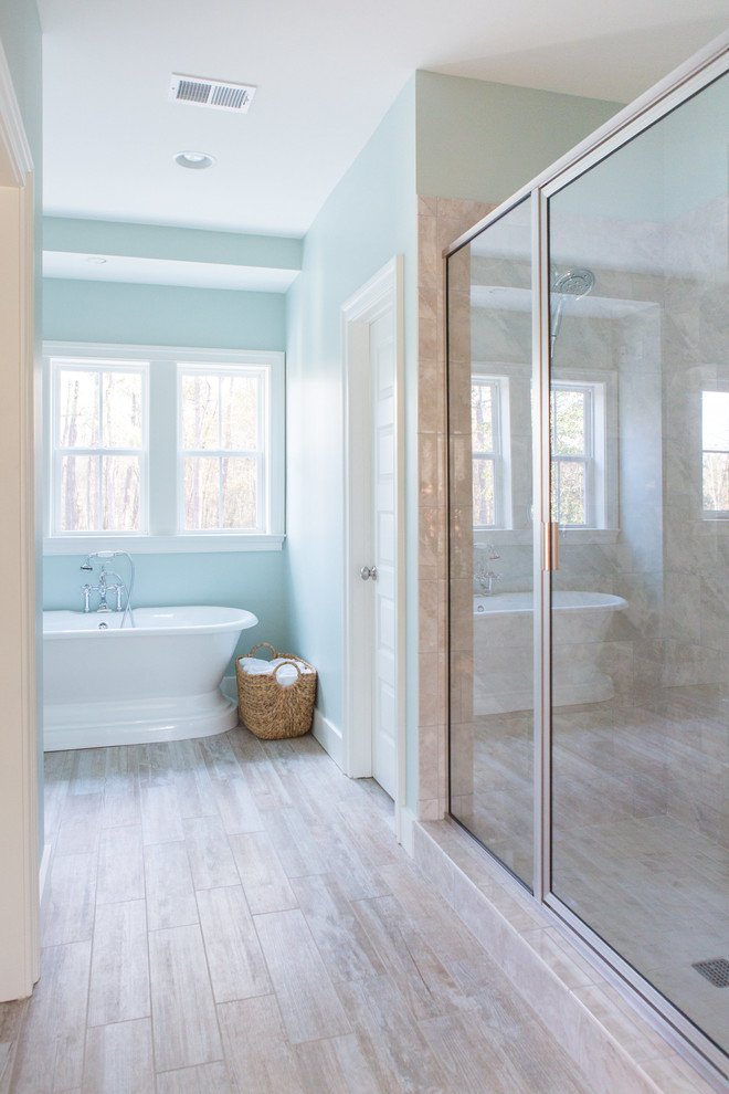 Mid-sized transitional porcelain tile and brown floor bathroom photo in Charleston with flat-panel cabinets, white cabinets, blue walls, an undermount sink and quartzite countertops