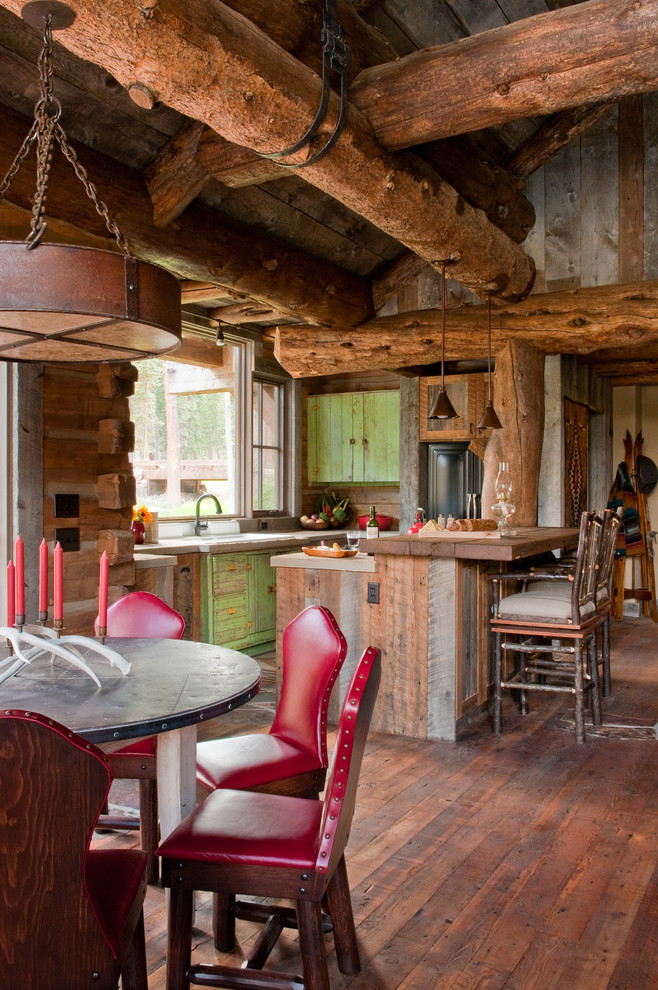 This is an example of a country eat-in kitchen in Other with distressed cabinets and wood benchtops.
