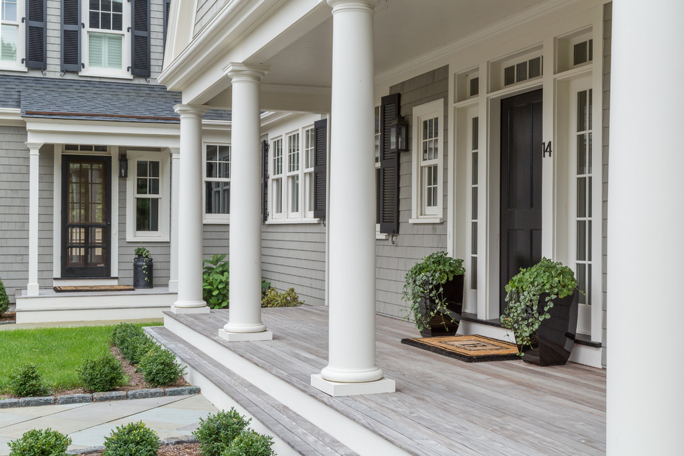 Elegant front porch photo in Boston with decking and a roof extension