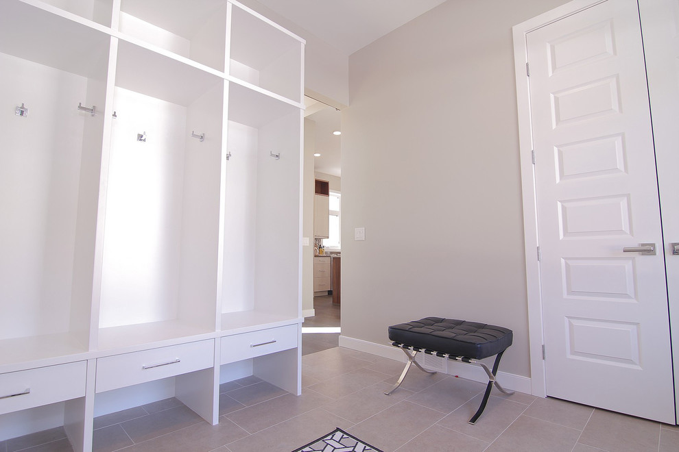 This is an example of a mid-sized modern mudroom in Other with grey walls and ceramic floors.