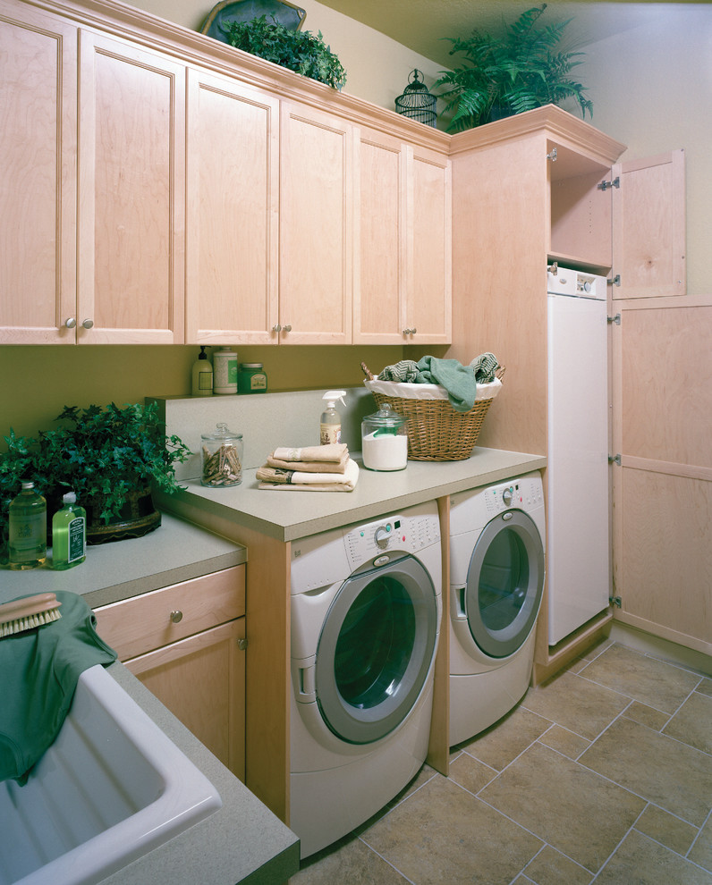 Design ideas for a large mediterranean galley dedicated laundry room in Miami with a drop-in sink, recessed-panel cabinets, light wood cabinets, laminate benchtops, travertine floors, a side-by-side washer and dryer and beige walls.