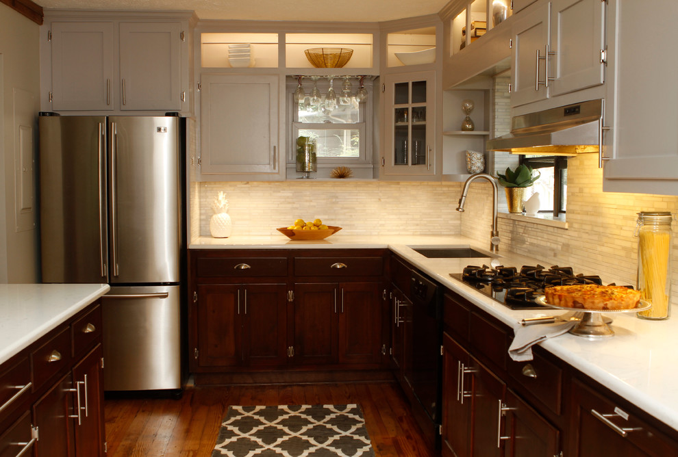 Enclosed kitchen - mid-sized transitional u-shaped light wood floor enclosed kitchen idea in Atlanta with an undermount sink, recessed-panel cabinets, dark wood cabinets, quartz countertops, white backsplash, stone tile backsplash, stainless steel appliances and an island