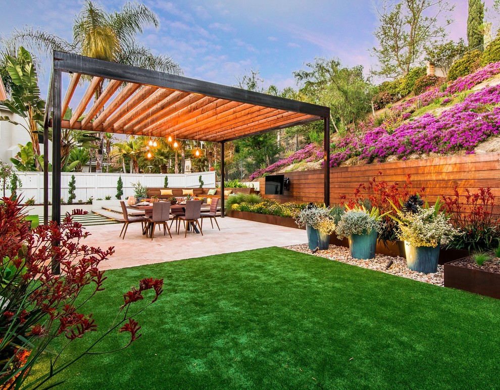 Design ideas for a mid-sized contemporary backyard full sun garden for spring in San Diego with concrete pavers.