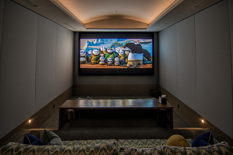Photo of a mid-sized country enclosed home theatre in Atlanta with carpet, a wall-mounted tv and grey walls.