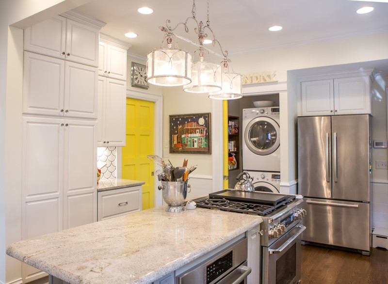 Design ideas for a mid-sized eclectic eat-in kitchen in Atlanta with a farmhouse sink, raised-panel cabinets, white cabinets, granite benchtops, white splashback, ceramic splashback, stainless steel appliances, dark hardwood floors and with island.