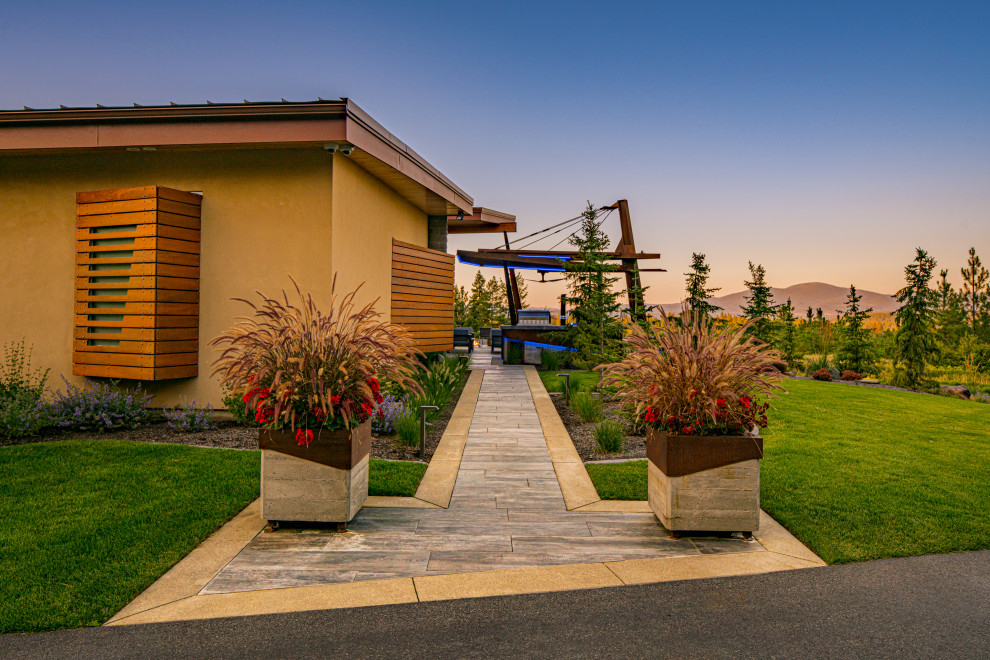 Photo of a mid-sized modern side yard garden in Seattle with a garden path and natural stone pavers.
