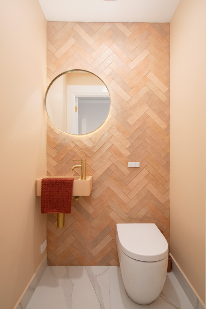 Inspiration for a small contemporary cloakroom in Newcastle - Maitland with white cabinets, a one-piece toilet, orange tiles, ceramic tiles, orange walls, marble flooring, a vessel sink, engineered stone worktops, white floors, white worktops, a floating vanity unit and all types of wall treatment.