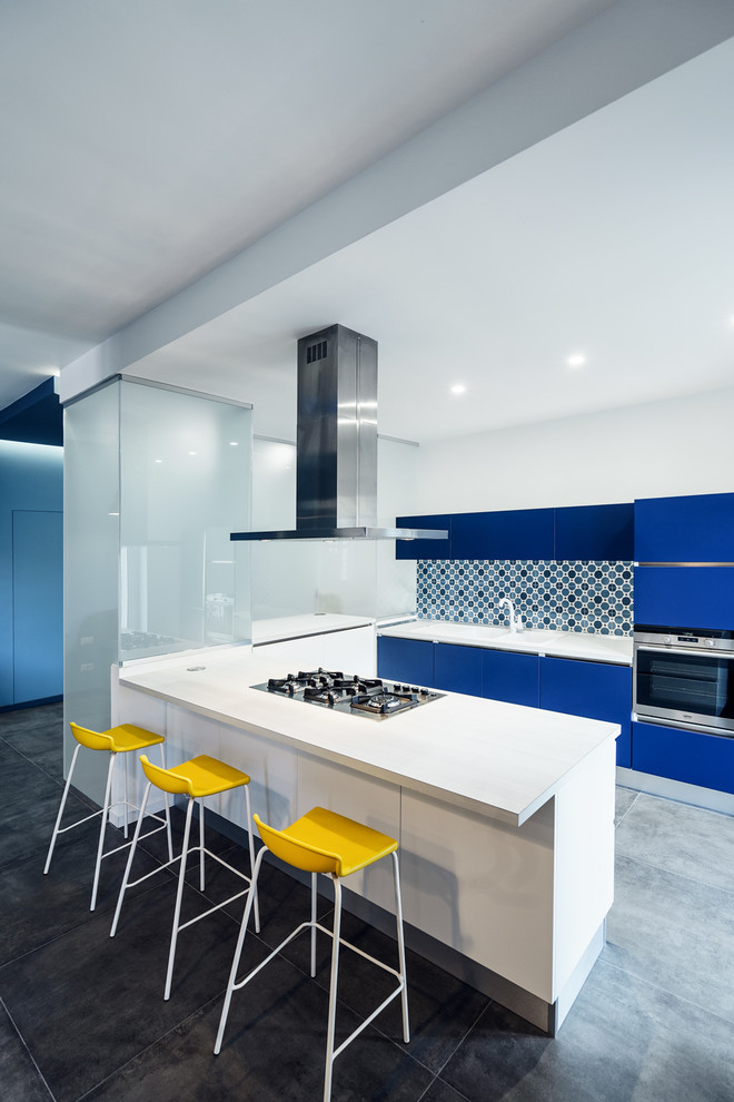 Design ideas for a large contemporary u-shaped open plan kitchen in Rome with flat-panel cabinets, blue cabinets, multi-coloured splashback, ceramic splashback and a peninsula.