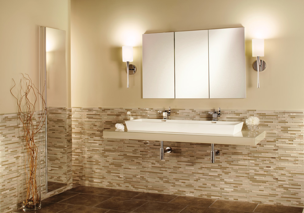Large transitional master bathroom in New York with a trough sink, glass-front cabinets, glass benchtops, multi-coloured tile, glass tile, beige walls and ceramic floors.