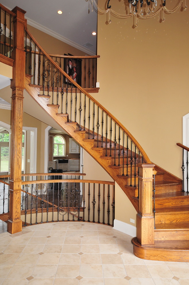 Traditional wood curved staircase in Chicago with wood risers.
