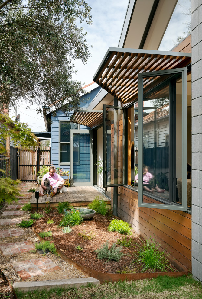 Photo of a small contemporary backyard deck in Melbourne with an awning.