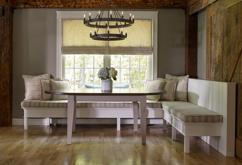 Inspiration for a large country dining room in Portland Maine with beige walls, light hardwood floors and exposed beam.