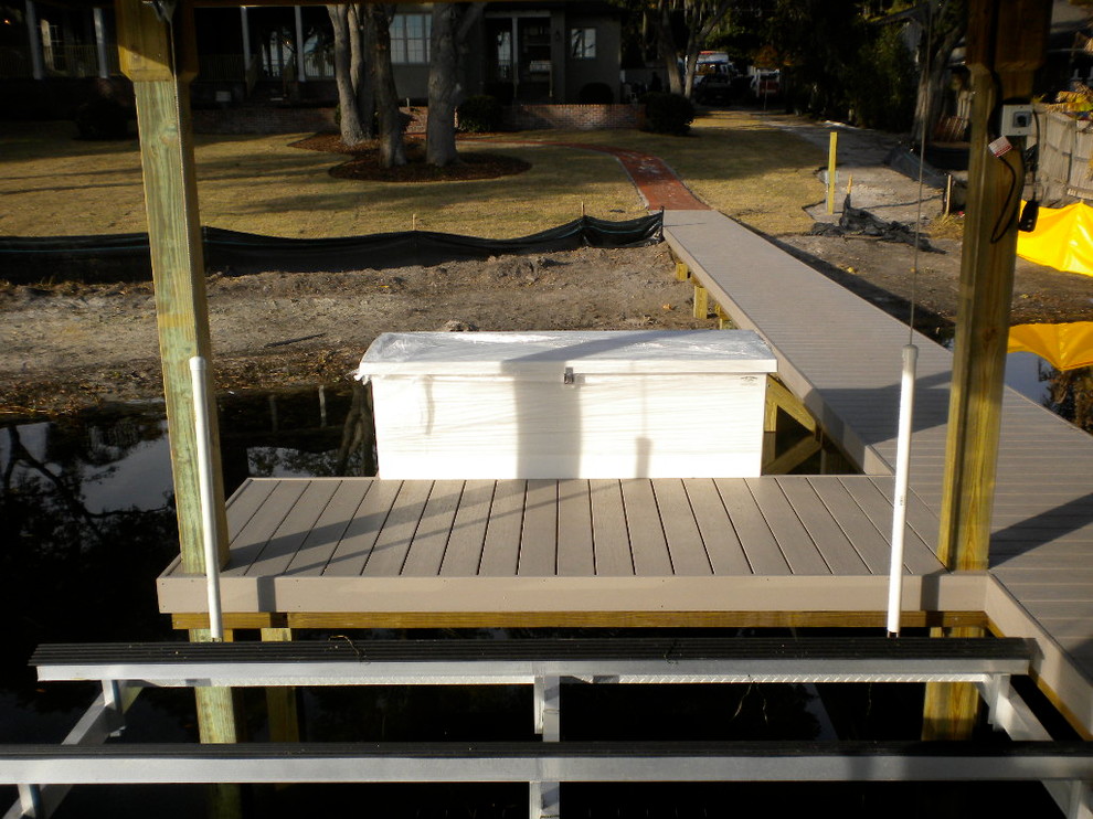 Inspiration for a mid-sized beach style backyard deck in Orlando with with dock.