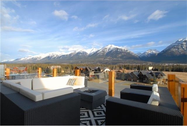 Mid-sized minimalist backyard deck photo in Calgary with a fire pit and no cover