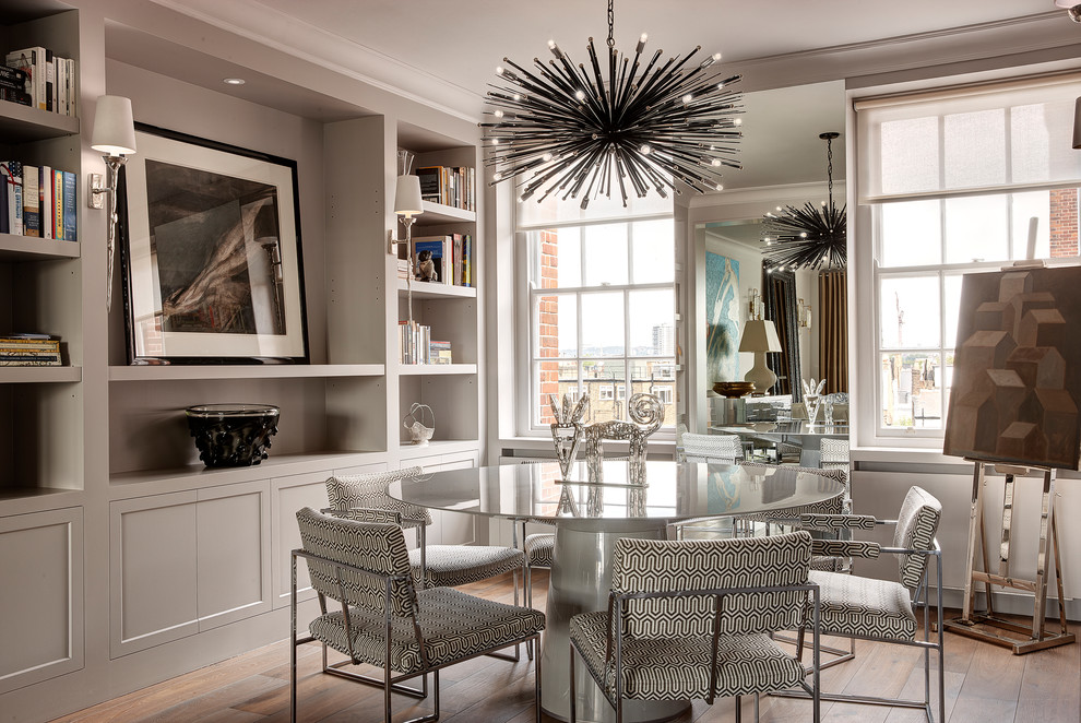 Transitional open plan dining in London with grey walls and medium hardwood floors.