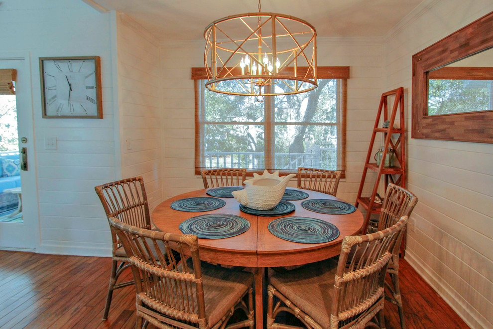 Inspiration for a small beach style dining room in Charleston with white walls, dark hardwood floors and brown floor.