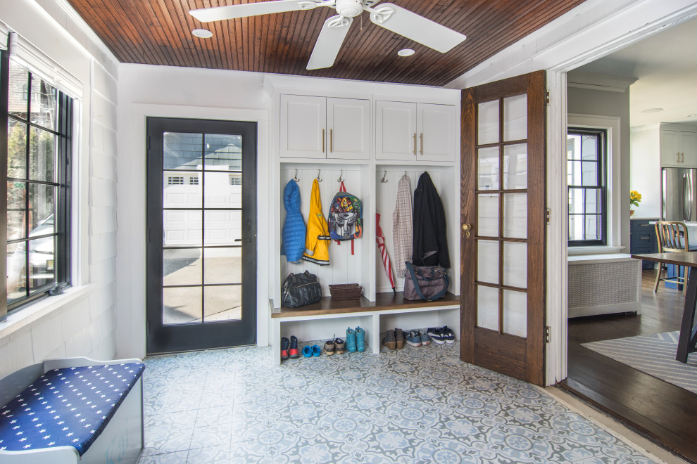 Photo of an expansive transitional mudroom in Newark with a single front door, white walls, porcelain floors, a metal front door and blue floor.