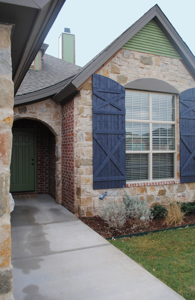Design ideas for a mid-sized eclectic one-storey brick red exterior in Austin with a gable roof.