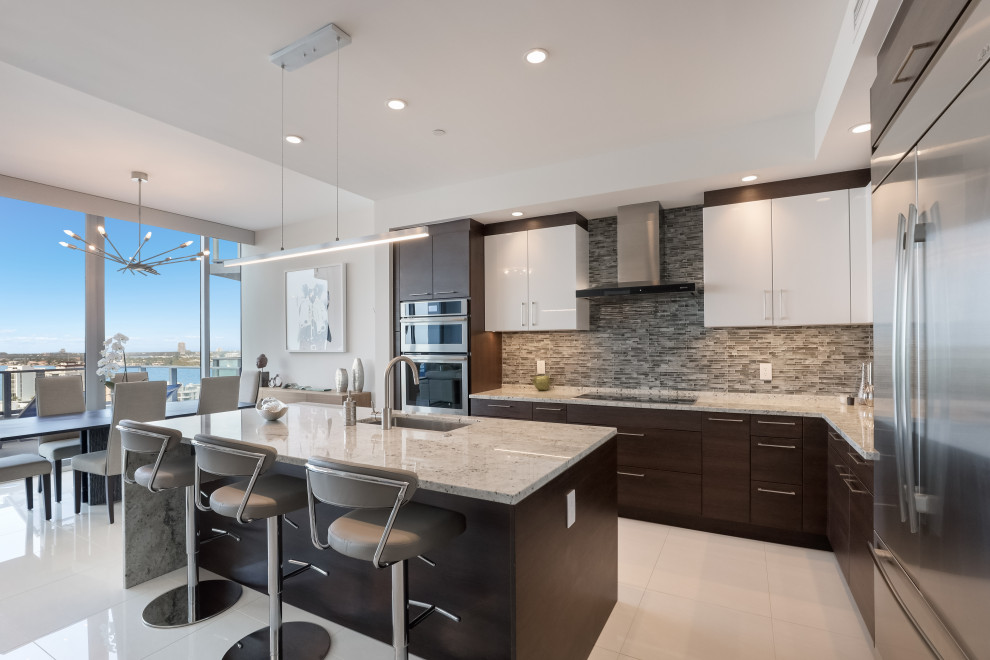 Design ideas for a contemporary eat-in kitchen in Tampa with flat-panel cabinets, dark wood cabinets, marble benchtops, multi-coloured splashback, glass tile splashback, stainless steel appliances, porcelain floors, with island, white floor and multi-coloured benchtop.
