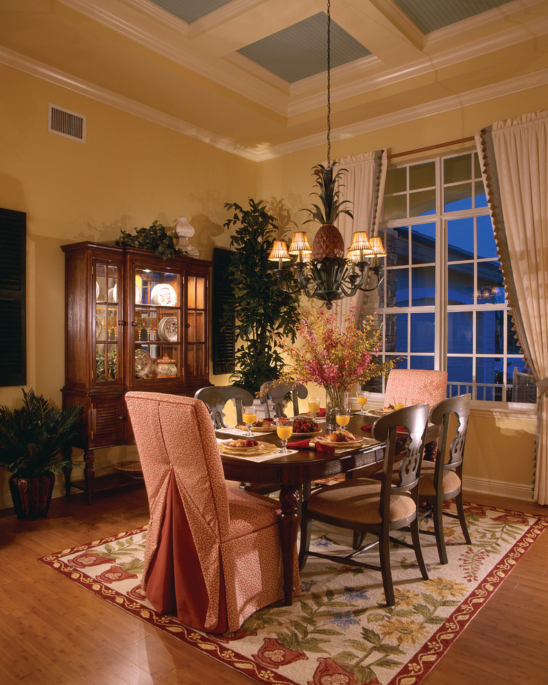 Design ideas for a large country separate dining room in Miami with yellow walls, medium hardwood floors and no fireplace.
