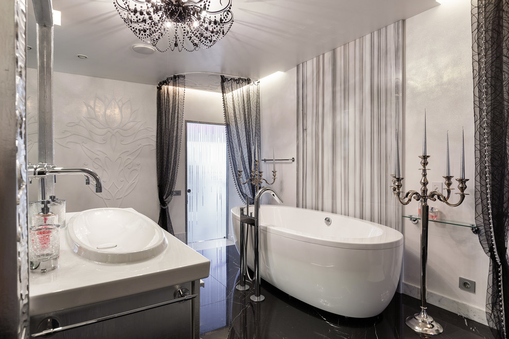 This is an example of a large eclectic bathroom in Saint Petersburg with a freestanding tub, white walls and marble floors.