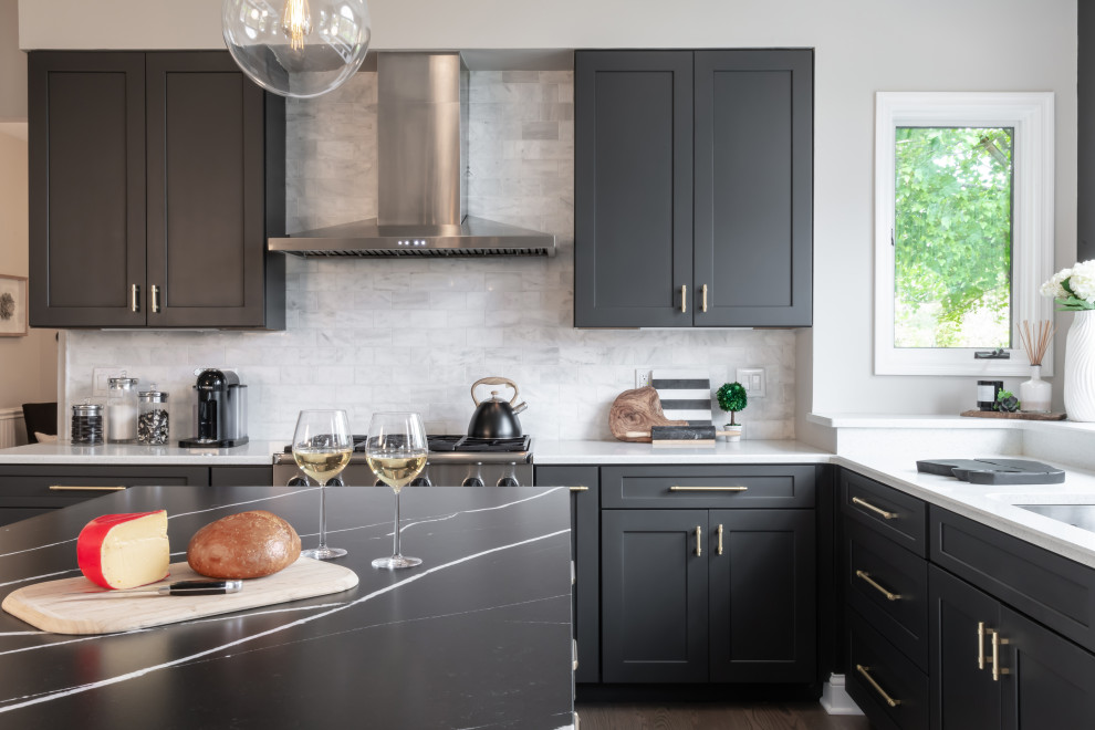 Design ideas for a traditional l-shaped kitchen/diner in St Louis with a submerged sink, grey cabinets, engineered stone countertops, grey splashback, stainless steel appliances, medium hardwood flooring, an island, brown floors, black worktops and shaker cabinets.