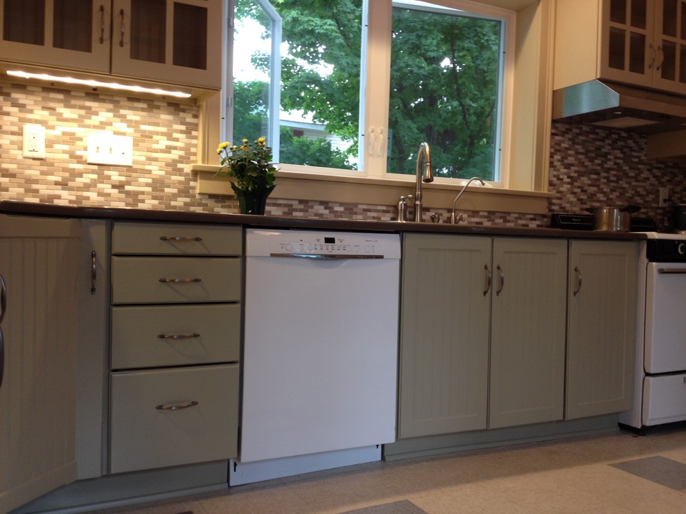 Inspiration for a mid-sized transitional l-shaped eat-in kitchen remodel with flat-panel cabinets and no island