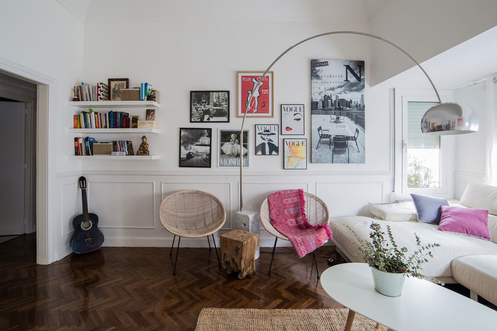 Large scandinavian open concept living room in Barcelona with white walls, no fireplace, dark hardwood floors and brown floor.