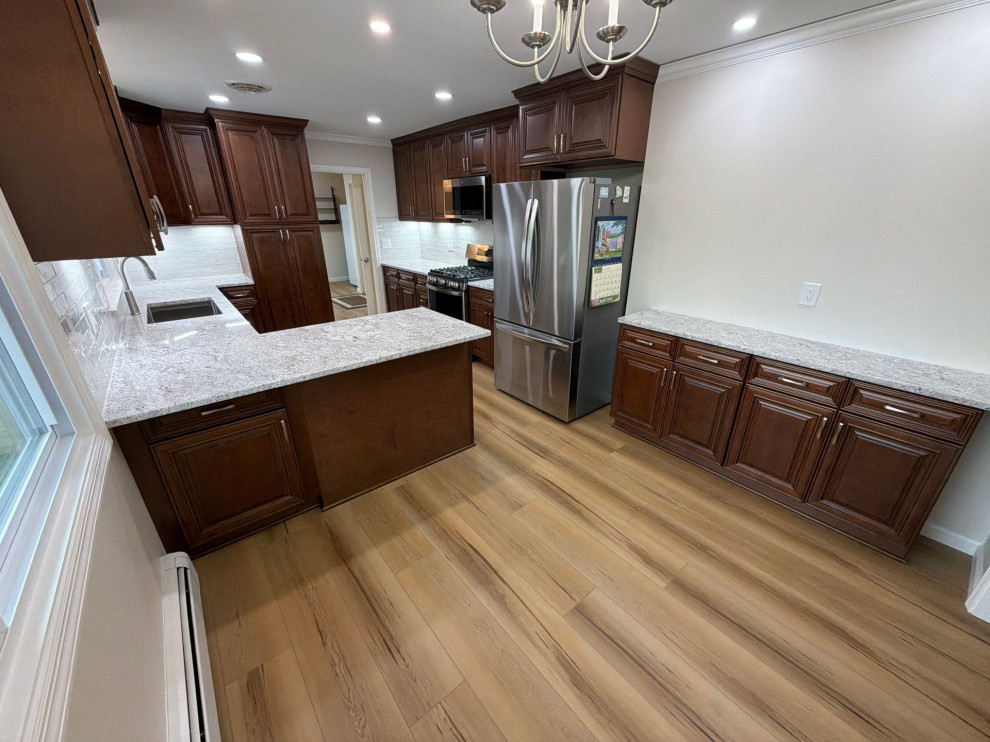 USCD cabinetry accompanied granite countertops, porcelain tile backsplash and Ca