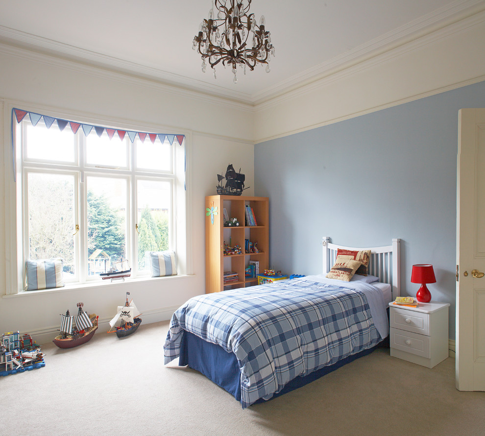 Design ideas for a contemporary kids' bedroom for kids 4-10 years old and boys in Dublin with blue walls and carpet.