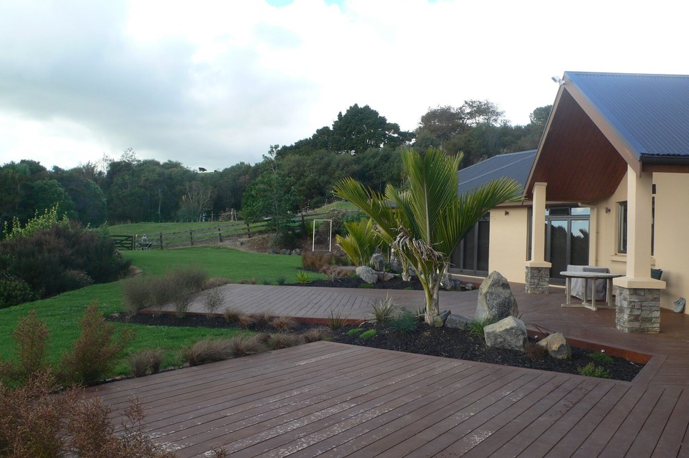 This is an example of a mid-sized traditional front yard full sun xeriscape in Auckland with decking.