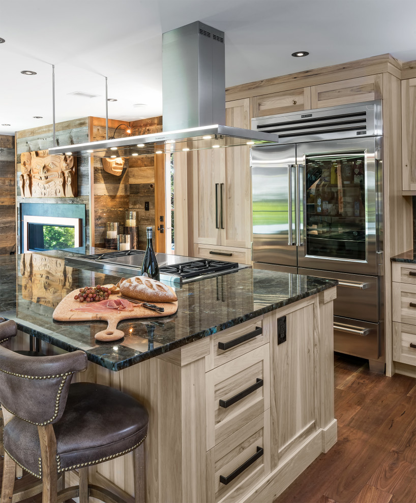 Inspiration for a mid-sized rustic l-shaped medium tone wood floor and brown floor eat-in kitchen remodel with an undermount sink, shaker cabinets, light wood cabinets, granite countertops, multicolored backsplash, granite backsplash, stainless steel appliances, an island and multicolored countertops