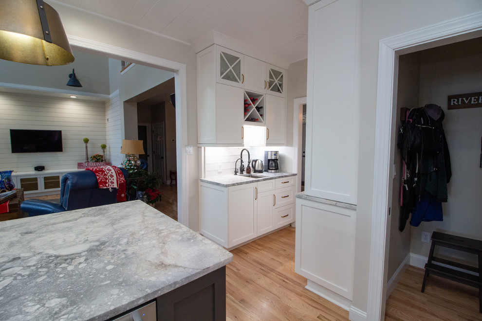 Inspiration for a large l-shaped eat-in kitchen remodel with shaker cabinets, white cabinets, granite countertops, an island and white countertops