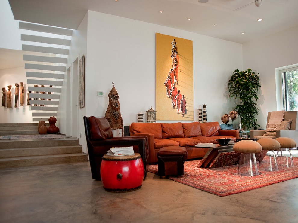 This is an example of an eclectic living room in Dallas with concrete floors.