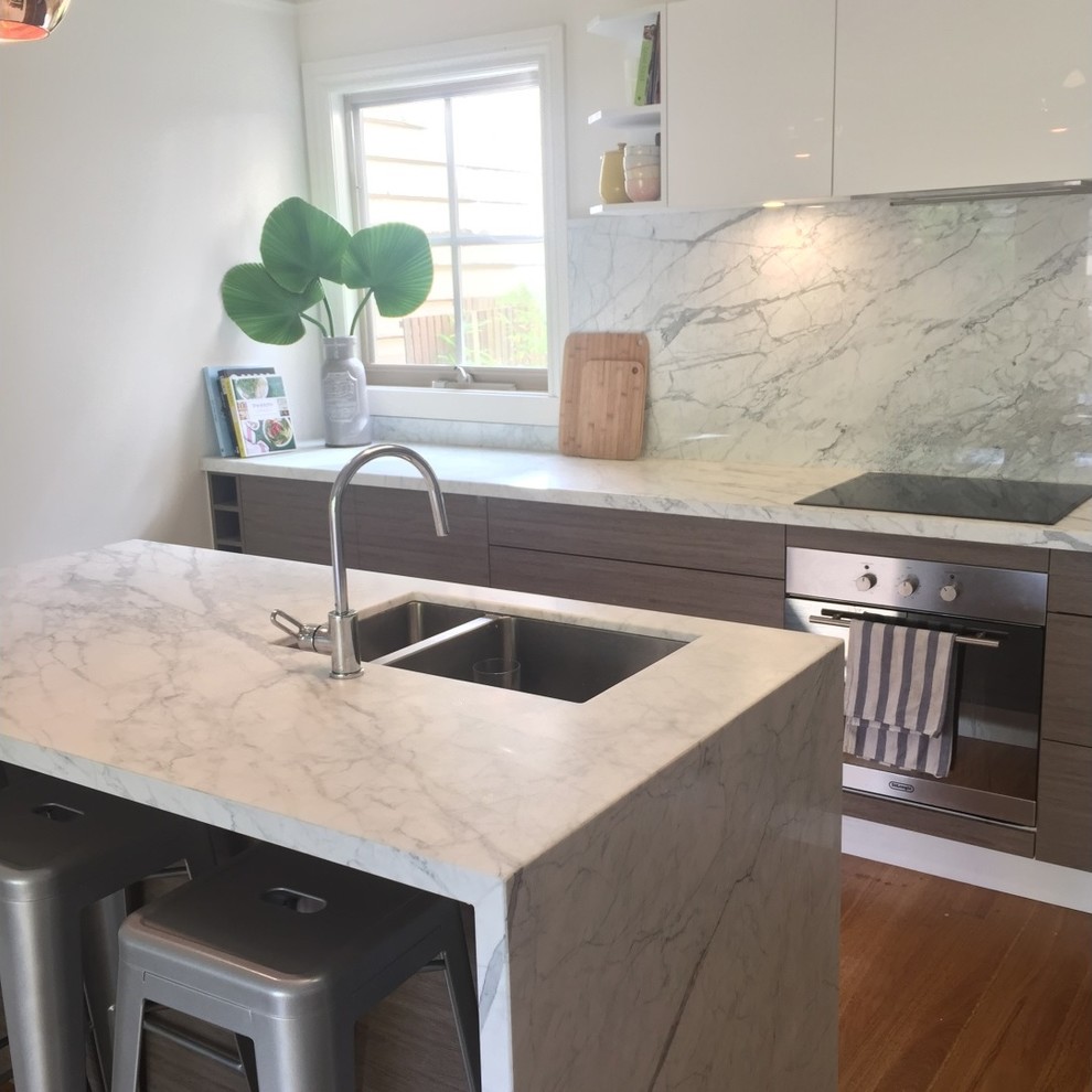 Design ideas for a mid-sized galley eat-in kitchen in Melbourne with an undermount sink, marble benchtops, white splashback, stone slab splashback and with island.