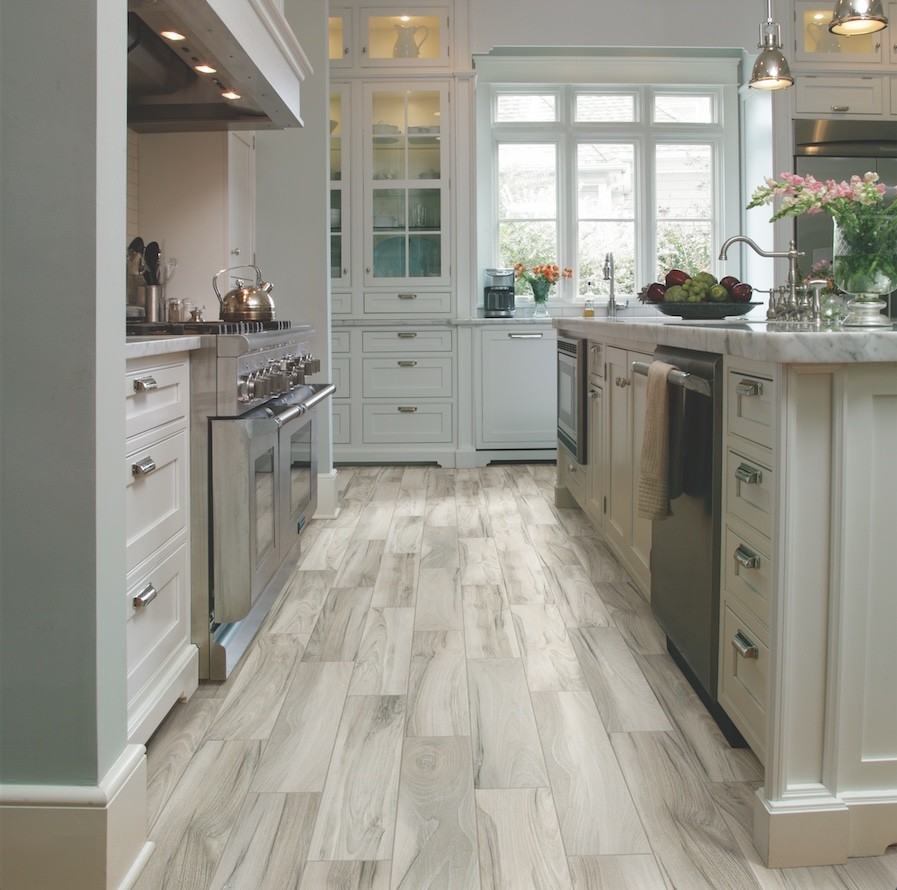 This is an example of a contemporary kitchen in Atlanta with porcelain floors and with island.