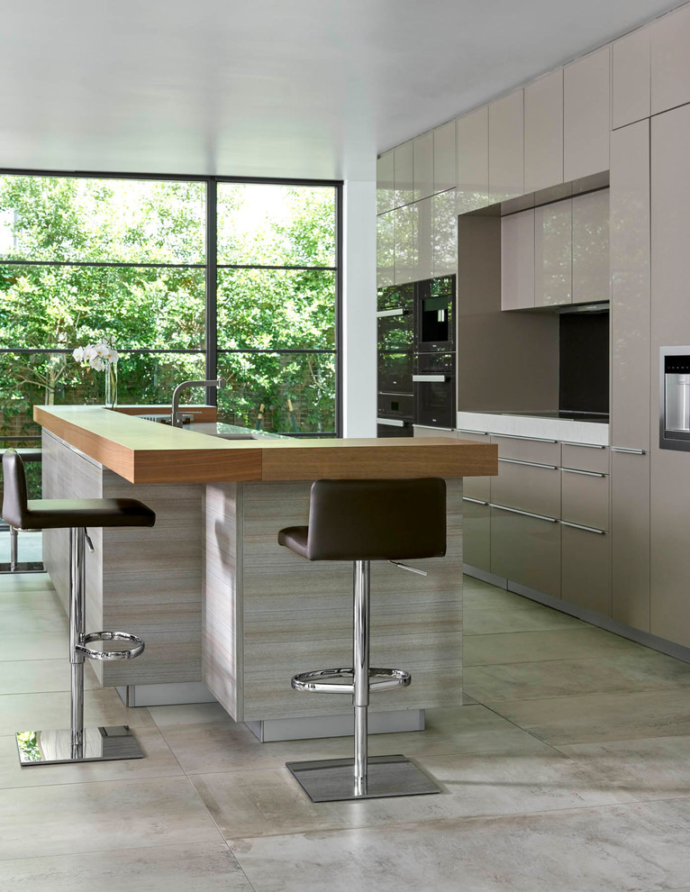 Photo of a large contemporary single-wall eat-in kitchen in Dallas with flat-panel cabinets, grey cabinets, with island, grey floor, an undermount sink, quartz benchtops, stainless steel appliances, concrete floors and white benchtop.