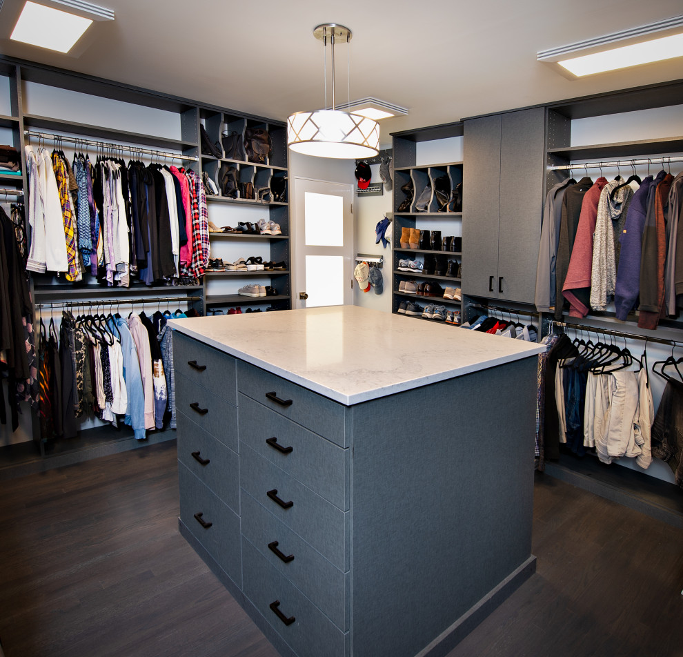 Photo of a medium sized modern gender neutral walk-in wardrobe in Chicago with flat-panel cabinets, grey cabinets, dark hardwood flooring and brown floors.