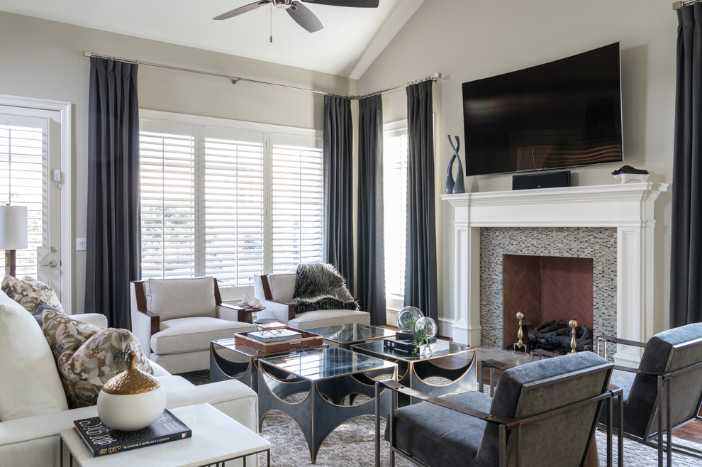 Large transitional open concept living room in Dallas with white walls, medium hardwood floors, brown floor, a standard fireplace, a wood fireplace surround and a wall-mounted tv.