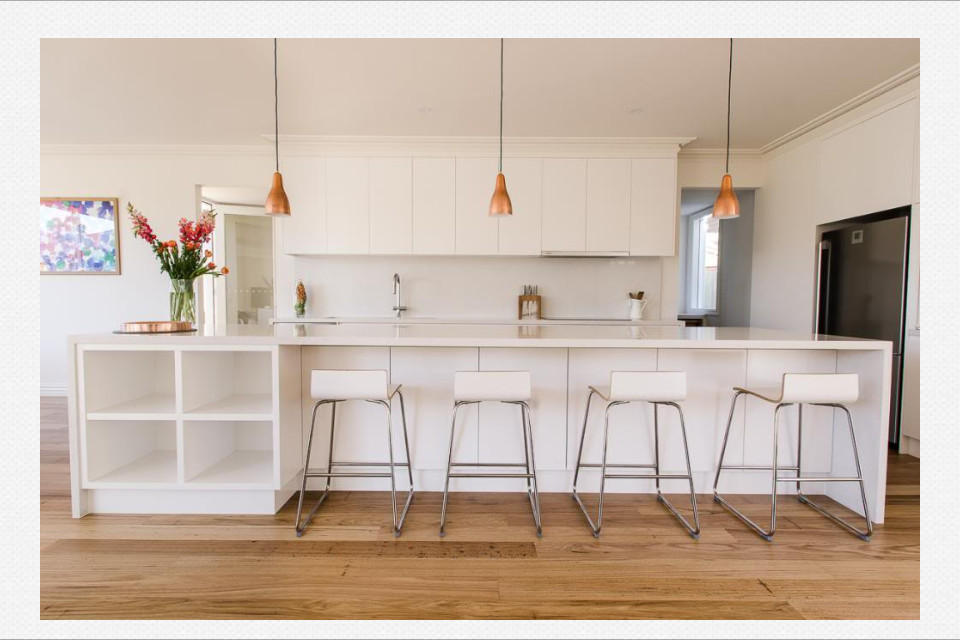 Photo of a large modern galley open plan kitchen in Melbourne with an undermount sink, white cabinets, marble benchtops, white splashback, stone slab splashback, stainless steel appliances, medium hardwood floors and with island.