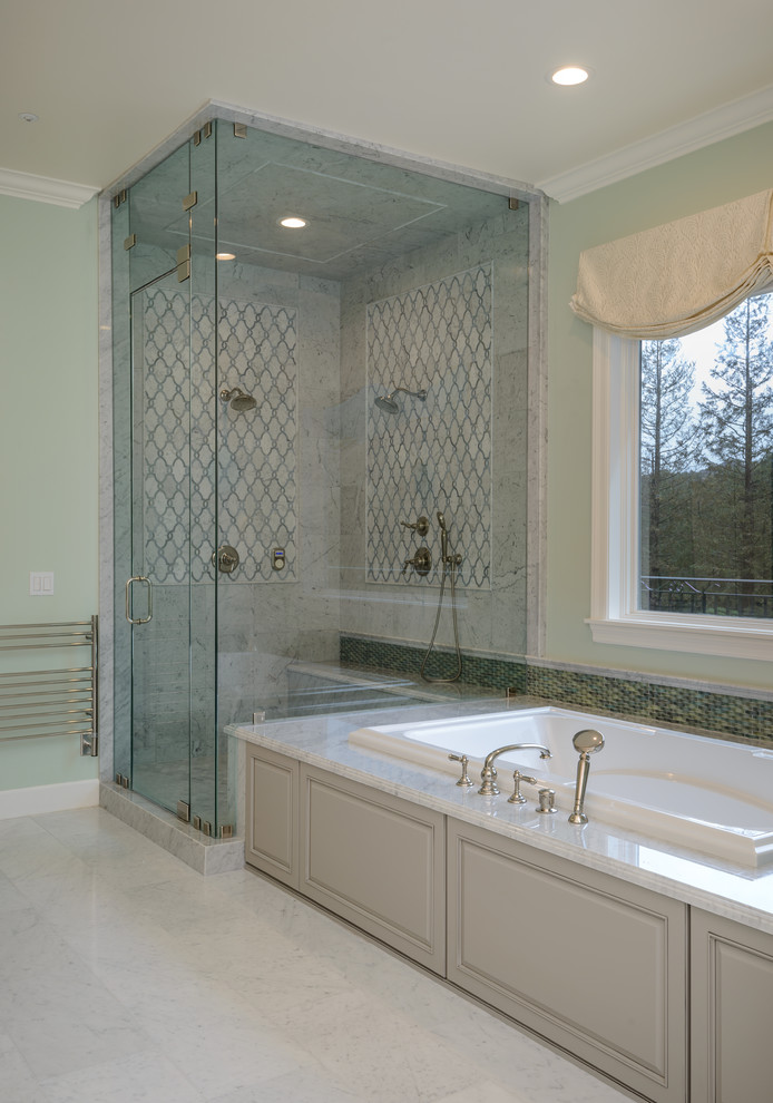 Inspiration for a large traditional master bathroom in Los Angeles with raised-panel cabinets, grey cabinets, a drop-in tub, a double shower, a bidet, multi-coloured tile, marble, green walls, marble floors, an undermount sink, marble benchtops, white floor and a hinged shower door.